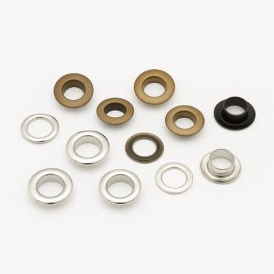 8.8mm EL2 beveled grommets in Antique Brass and Nickel finishes with matching washers, arranged on a white background.-Avetco