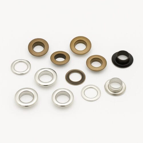 8.8mm EL2 beveled grommets in Antique Brass and Nickel finishes with matching washers, arranged on a white background.-Avetco