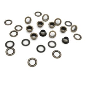 Antique Brass beveled grommets with washers on a white background, shown in a scattered, elegant layout.-Avetco