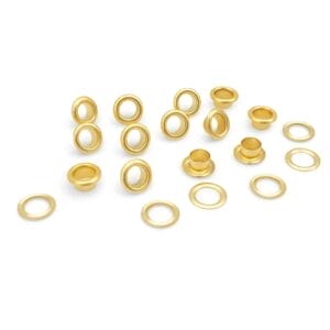 Multiple gold grommets and washers arranged on a white background. -Avetco