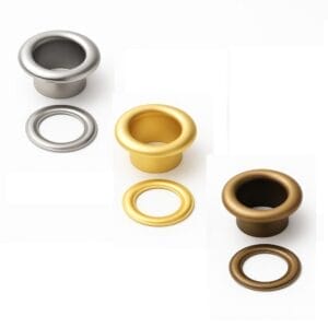 Three beveled grommet sets in nickel, gold, and antique brass finishes with matching washers on a white background. -Avetco