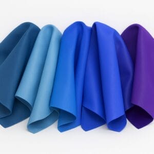 Draped lamb leather swatches in shades of blue and purple on a white background-Avetco