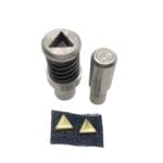 10mm Triangle Nailhead die setter tools with gold triangular nailheads attached to dark fabric swatch, shown on a white background-Avetco