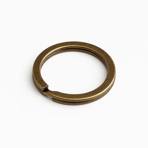 Antique brass split key ring on a white background.-Avetco