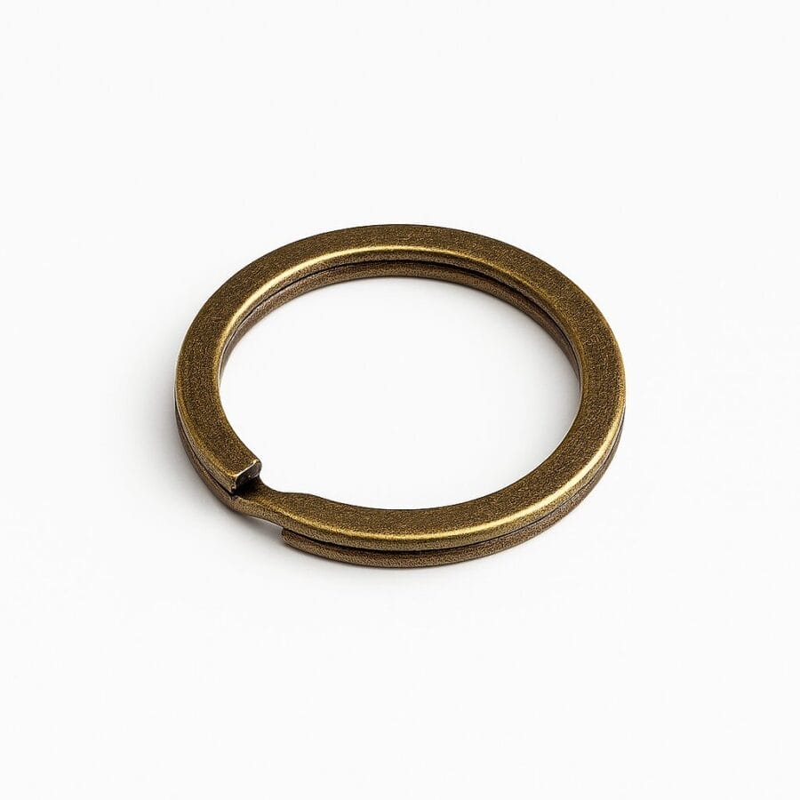 Antique brass split key ring on a white background.-Avetco