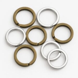 Antique brass and nickel split key rings arranged together on a white background.-Avetco