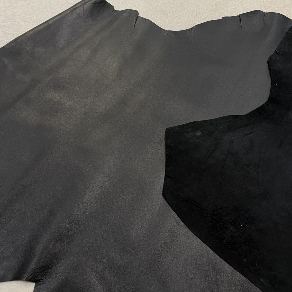 Smooth black lambskin leather hide surface, thin and lightweight