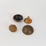 R598 15mm decorative dome rivet in Antique Brass finish – double cap design, engraved dome with Greek swirl pattern.