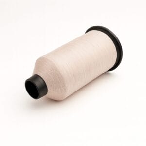 Spool of bone-colored nylon sewing thread on a white background – Avetco