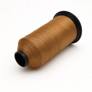 Golden brown mustard nylon thread spool on white background – Avetco B33 B69