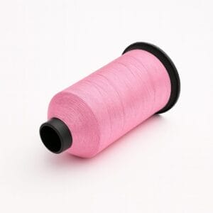 Pink nylon bonded thread spool on a pure white background – Avetco